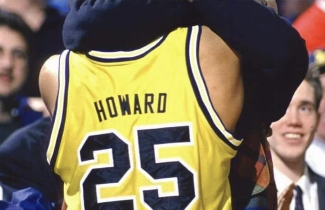 The back of Juwan Howard's U-M basketball jersey with Aaron Saari, the basketball student manager at the time, visible in the background.