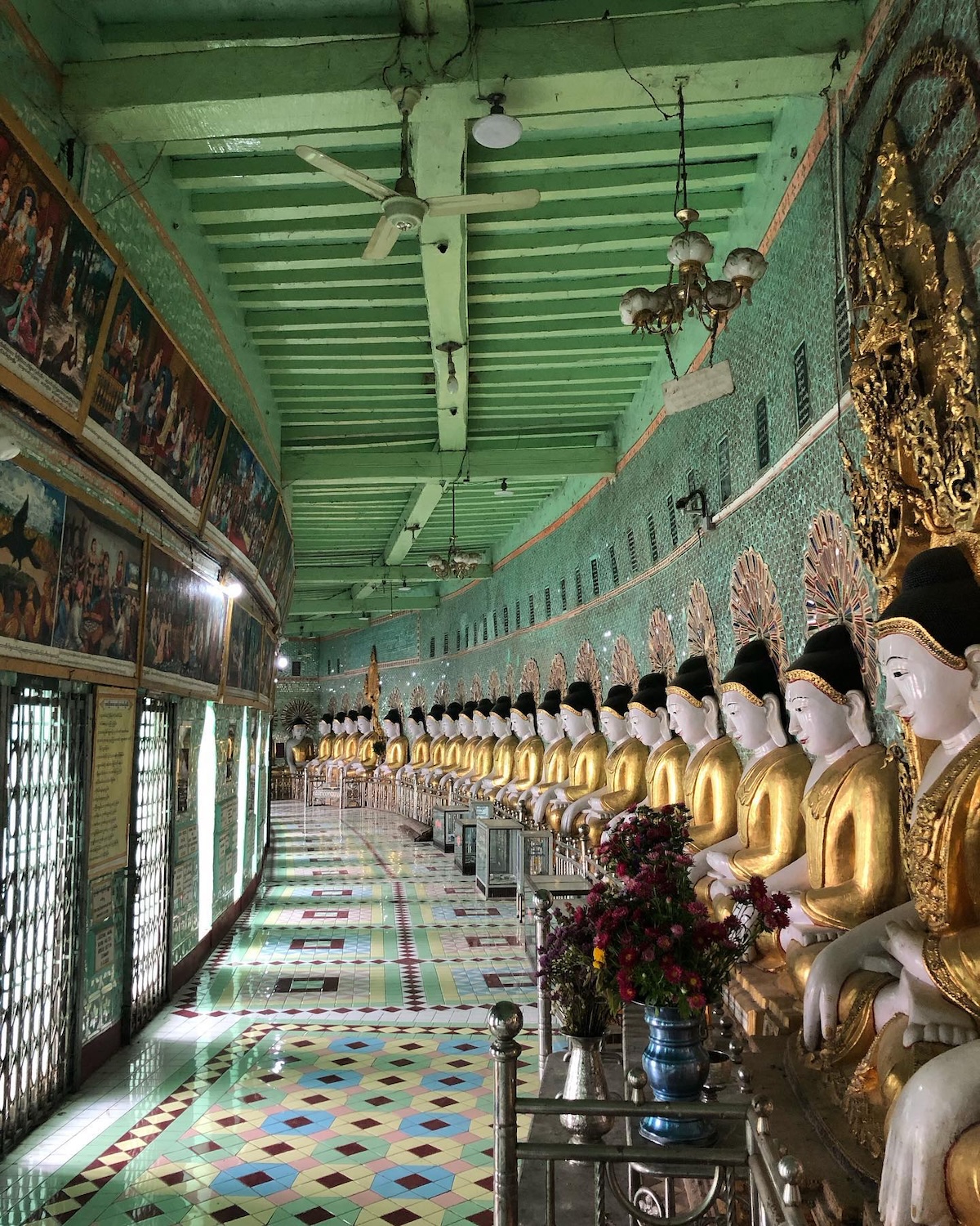 A line of Buddha statues in a temple in Myanmar