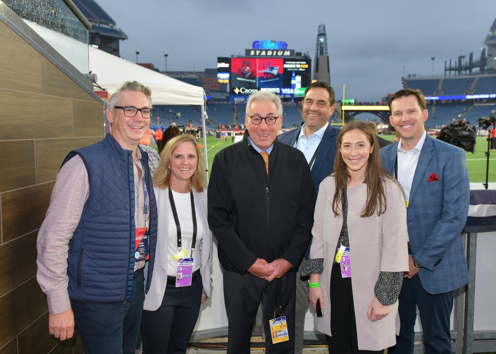 Members of the UnitedHealth Group sponsorships team before a Patriots game with famed ESPN reporter Sal Paolantonio 